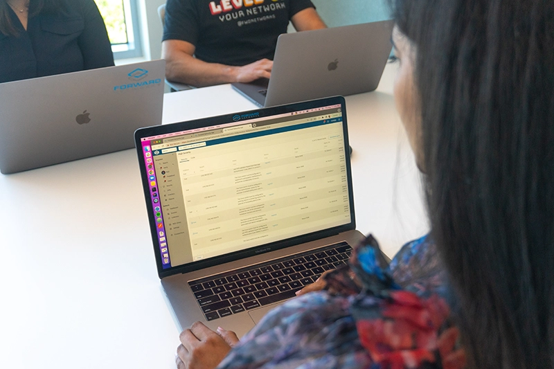 Person viewing laptop with data on it