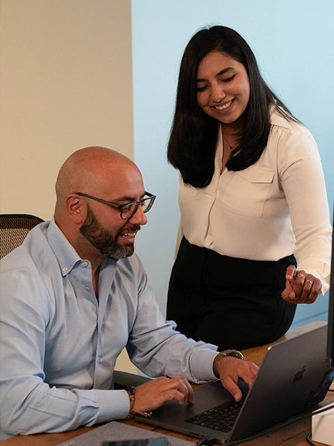 Forward Networks employees viewing a laptop
